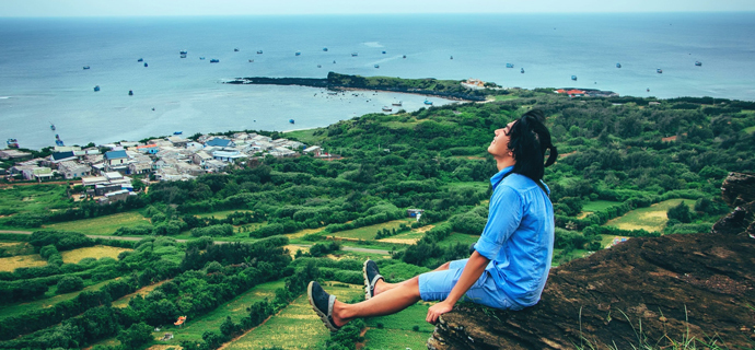 Man looks out over beautiful view of trees