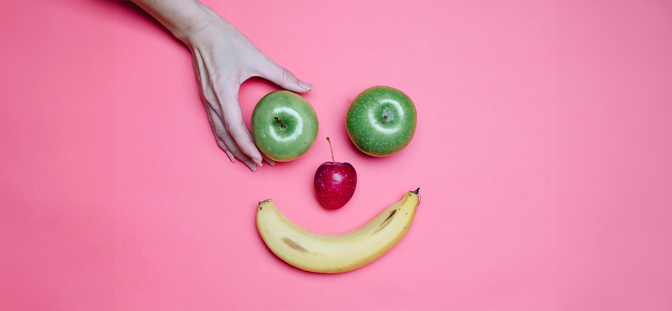 hand reaching for fruit.